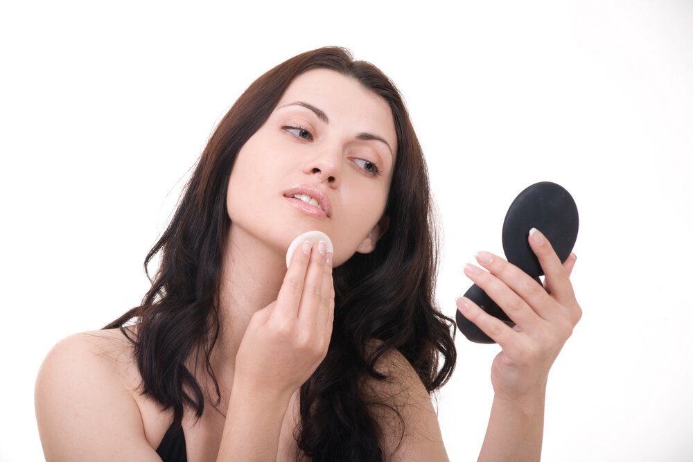 Woman treating her zit. 